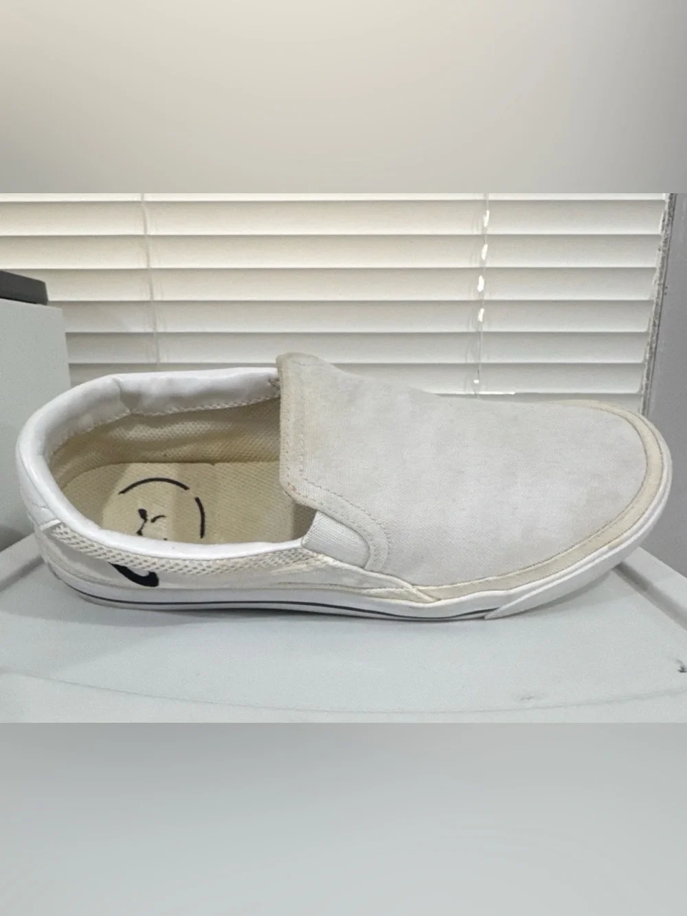 Nike Women’s White Slip-On Sneakers with Black Swoosh Accent
